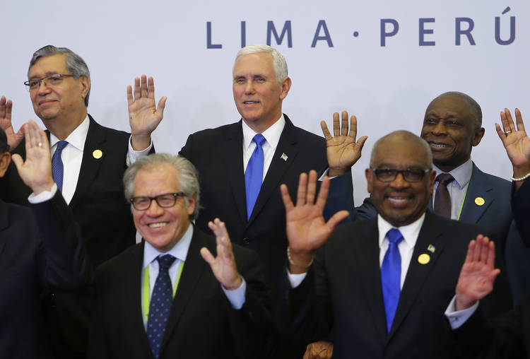 Vice President Pence waves with other heads of state during the official photo of the Summit of the Americas in Lima, Peru. (Karel Navarro/AP)