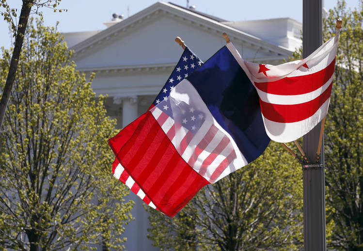 French flags are flying all over downtown Washington, including outside the White House. (Alex Brandon/AP)
