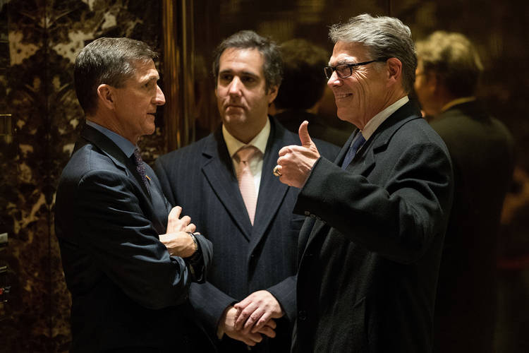Michael Flynn, Michael Cohen and Rick Perry huddle in the lobby of Trump Tower on Dec. 12, 2016. (Drew Angerer/Getty Images)