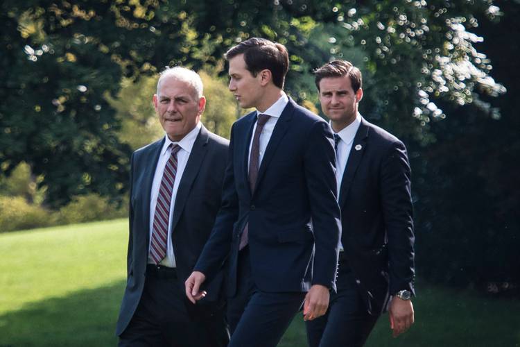 Chief of Staff John Kelly, senior adviser Jared Kushner and then-Trump aide John McEntee walk on the South Lawn to Marine One. (Jabin Botsford/The Washington Post)