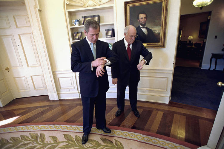 George W. Bush and Dick Cheney look at their watches in the Oval Office. (Eric Draper/George W. Bush Presidential Library)