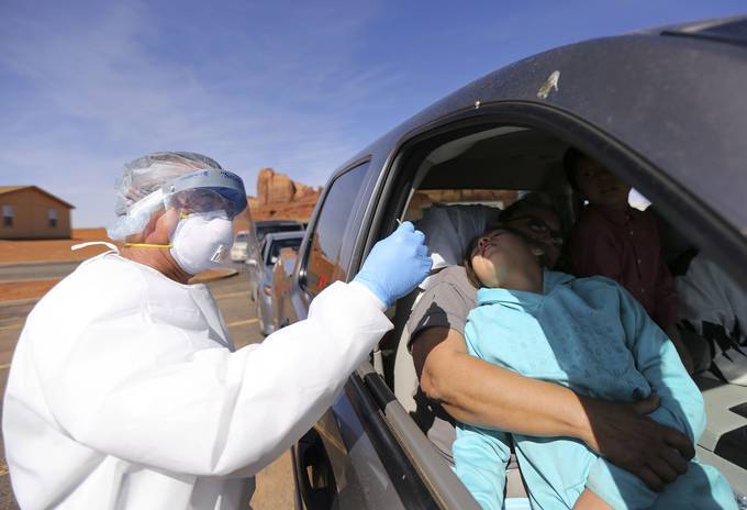 Vehicles line up for coronavirus testing outside of the Monument Valley Community Health Center in Oljato-Monument Valley, San Juan County. The Navajo Nation has one of the highest infection rates in the country. (Kristin Murphy/Deseret News/AP)