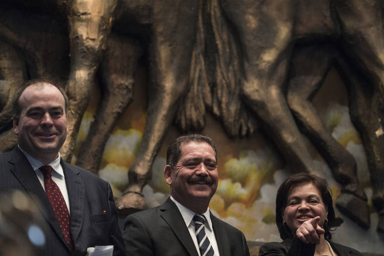 Fritz Kaegi, left, joins Jesus "Chuy" Garcia and his wife, Evelyn, for an election night celebration. (Max Herman/Chicago Sun-Times via AP)