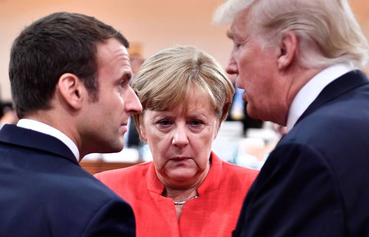 Emmanuel Macron, Angela Merkel and President Trump speak at the G-20 meeting in Hamburg. (John MacDougall/AFP/Getty)