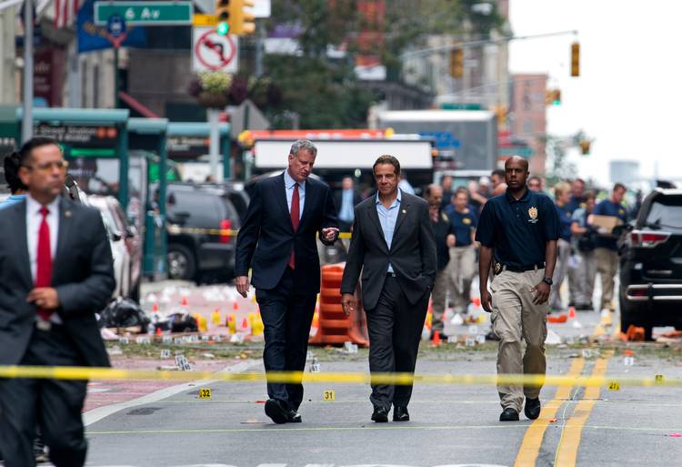 Mayor Bill de Blasio and New York Gov. Andrew Cuomo walk near the scene of an explosion on West 23rd street in Manhattan. (Craig Ruttle/AP)