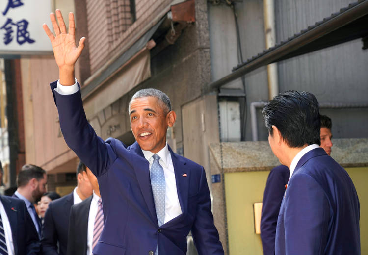 Barack Obama waves as he and Japanese Prime Minister Shinzo Abe go out for sushi in Tokyo's Ginza shopping district last month. (Shizuo Kambayashi/AP)