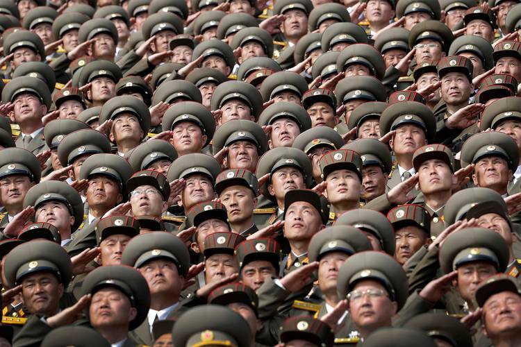 North Korean soldiers salute while the national anthem is played during a military parade. (Wong Maye-E/AP)