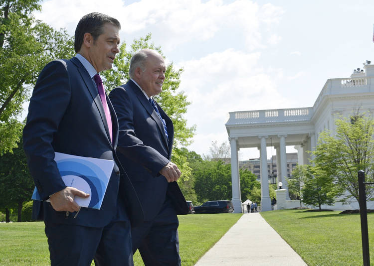 Association of Global Automakers President and CEO John Bozzella, left, and Ford Motor Company CEO Jim Hackett, right, arrive for a meeting with Trump at the White House. (Susan Walsh/AP)