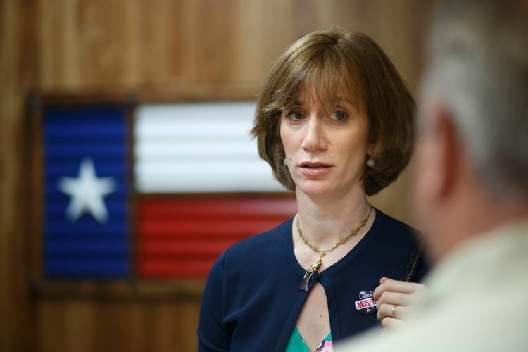 Laura Moser picks up campaign materials at a print shop in Houston. (Michael Stravato/For the Washington Post)