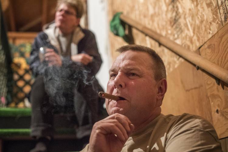 Sen. Jon Tester enjoys a cigar after a long day of work on his farm in Big Sandy, Mont. (Melina Mara/The Washington Post)