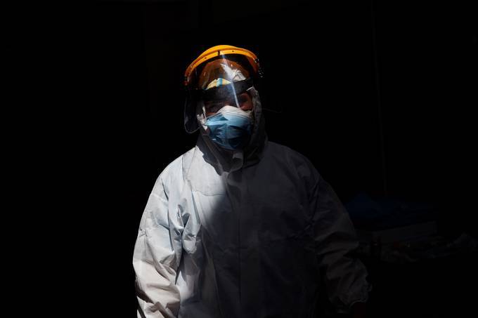 A doctor wears a face shield and a protective suit while working at the ICU of the Hospital del Mar clinic in Barcelona, Spain. (Alejandro Garcia/EPA-EFE/Shutterstock)&nbsp;