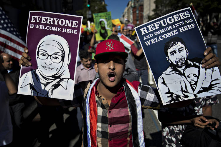 A demonstrator protests against President Trump's travel ban in Washington. (Andrew Harrer/Bloomberg News)