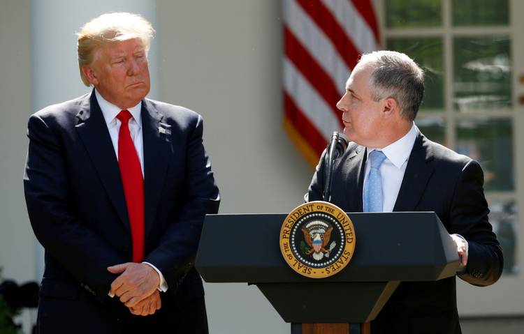 Trump listens to Scott Pruitt after announcing his decision that the United States will withdraw from the Paris climate agreement in the Rose Garden last year. (Kevin Lamarque/Reuters)