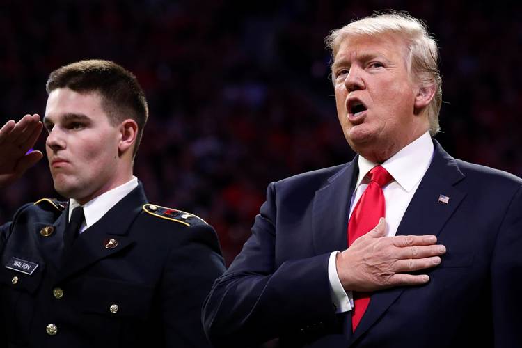 President Trump sings along with the national anthem before the NCAA college football championship game in January. (Jonathan Ernst/Reuters)