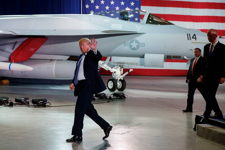 Donald Trump waves as he walks off after participating in a roundtable discussion on tax policy at a Boeing facility in St. Louis on Wednesday. (Evan Vucci/Associated Press)