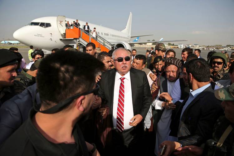 Afghan first vice president, a former Uzbek warlord, Abdul Rashid Dostum (center) and members of his entourage arrive at Kabul International Airport on Sunday. (Rahmat Gul/AP)