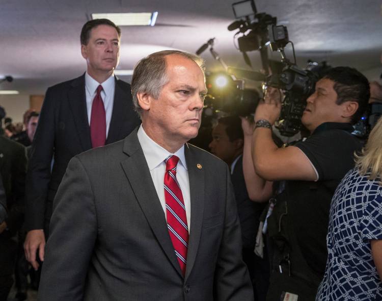James Wolfe, a former Senate Intelligence Committee staffer, with James Comey. (J. Scott Applewhite/AP)