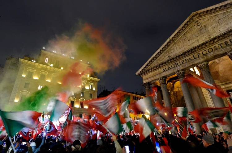 Activists with Casapound, a far-right movement turned political party, wave flags during a rally at the Pantheon square in Rome. (Andreas Solaro/AFP/Getty Images)