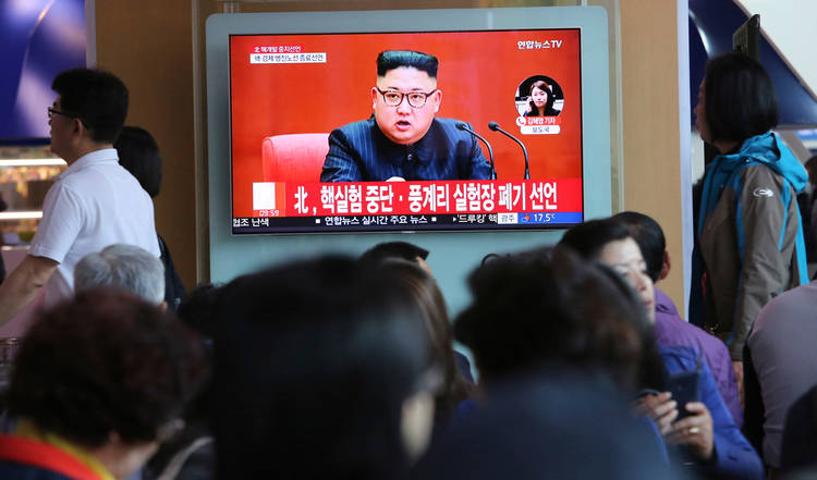 People watch a TV screen at the railroad station in Seoul on Saturday that shows an image of North Korean leader Kim Jong Un. The chryon reads: “North Korea says it has suspended nuclear tests.” (Ahn Young-joon/AP)