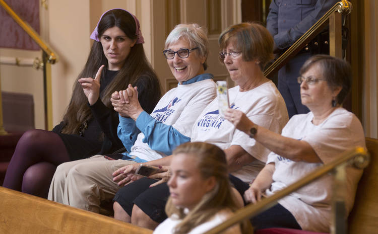 Del. Danica Roem (D-Prince William) talks with supporters of Medicaid expansion as they celebrate a vote in the gallery of the Virginia Senate at the capitol in Richmond on Wednesday. (Steve Helber/AP)