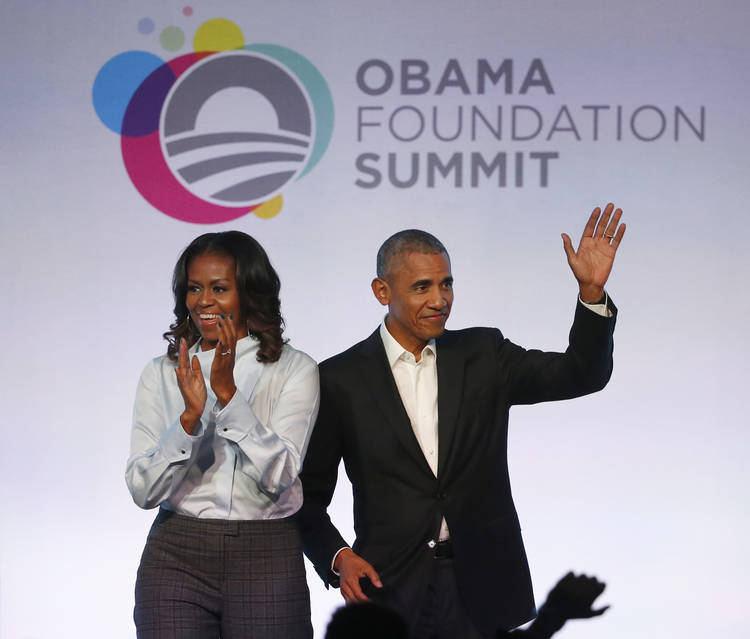 Barack and Michelle Obama arrive for the first session of the Obama Foundation Summit in Chicago. (Charles Rex Arbogast/AP)