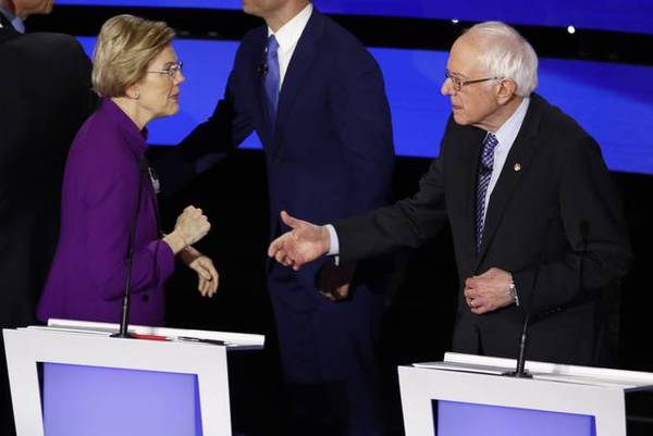 Warren and Sanders talk after the debate. (AP Photo/Patrick Semansky)