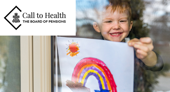 Child holding drawing of rainbow at window