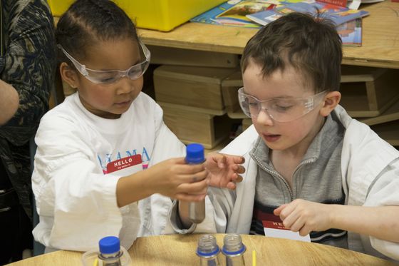 Two young children working on a science experiment.
