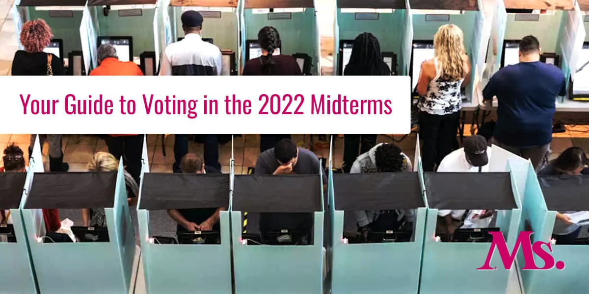 Photo of a row of voting booths with people voting in them. A Feminist Guider to the 2022 Midterms