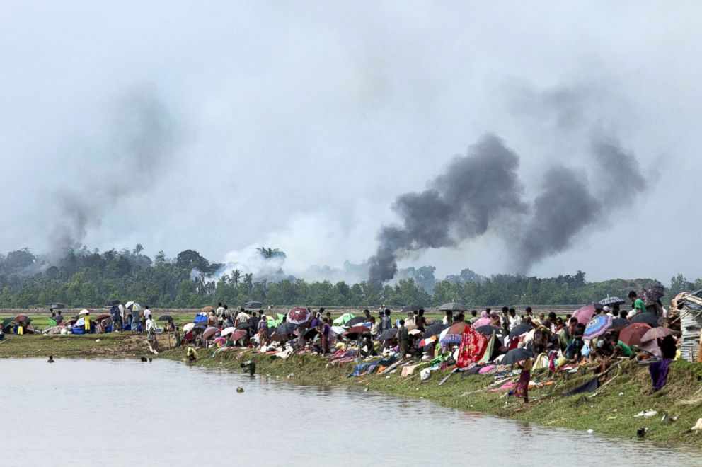 Smoke billows above what is believed to be a burning village in Myanmar's Rakhine state as members of the Rohingya Muslim minority take shelter in a no-man's land between Bangladesh and Myanmar in Ukhia, Bangladesh, Sept. 4, 2017.