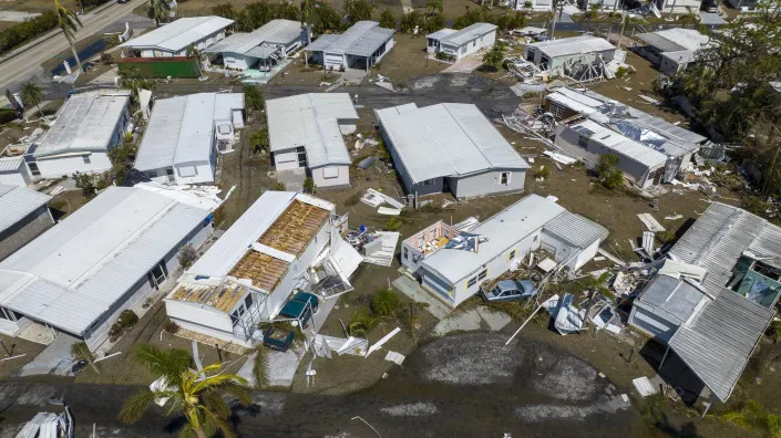 This is an aerial view of a damaged trailer park after Hurricane Ian passed by the area Saturday, Oct. 1, 2022, in Fort Myers, Fla. (AP Photo/Steve Helber)