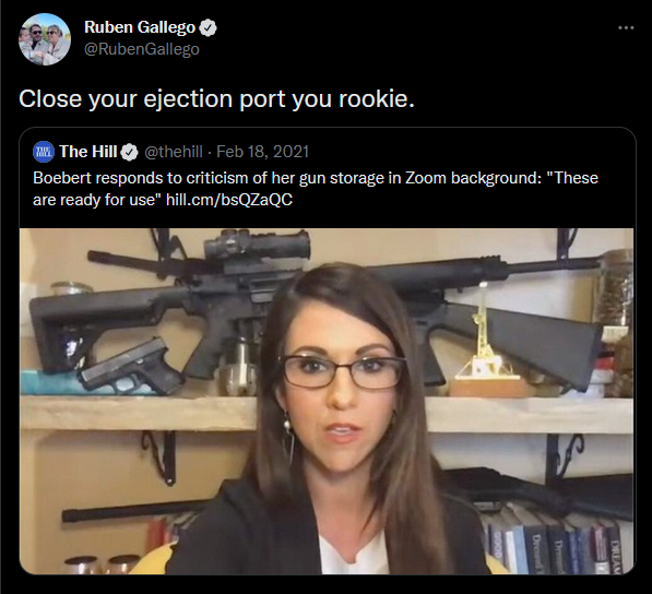 Reply tweet by Ruben Gallego: Close your ejection port you rookie. Original tweet by The Hill: Boebert responds to criticism of her gun storage in Zoom background: 'These are ready for use.