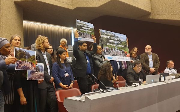 Campaigners with signs at the Basel Convention COP