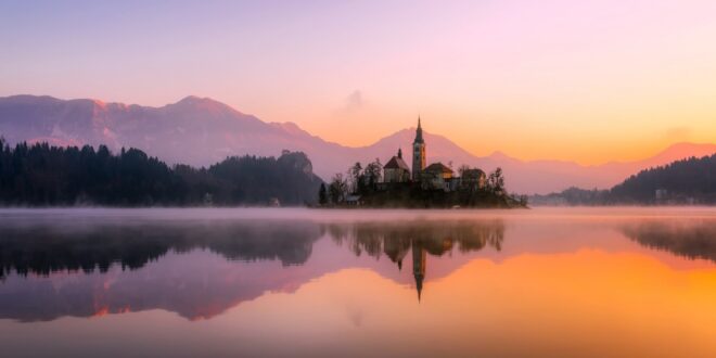 sunrise over lake and church