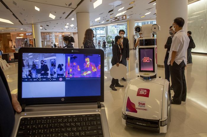 Mall In Bangkok Uses A Robot To Measure People's Body Temperatures As They Pass By