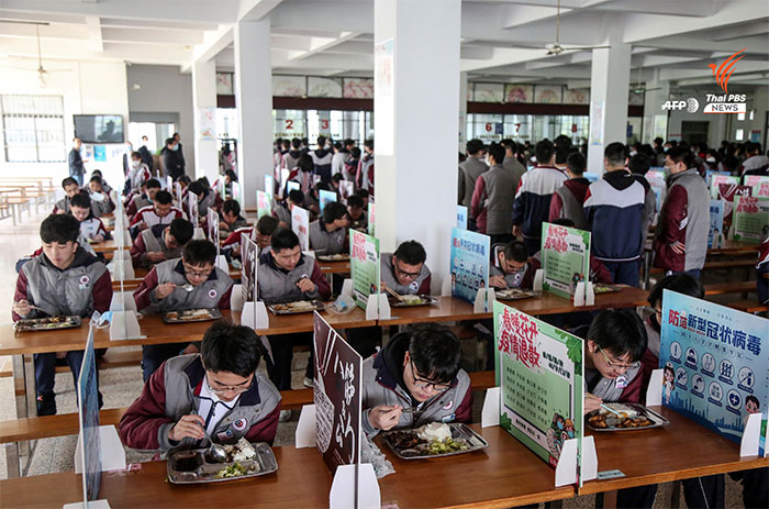 In China Students Eat Lunch By Themselves, With Dividers Set Up Between Them