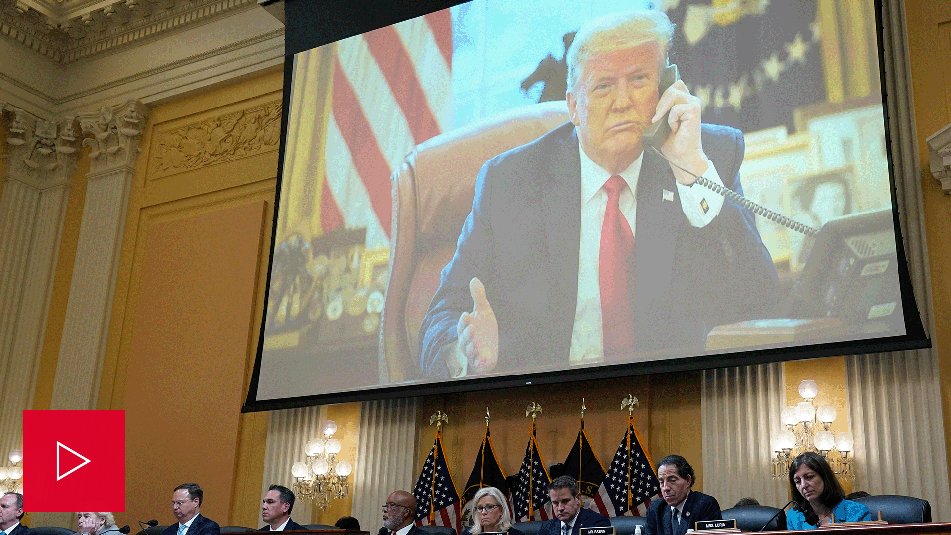 An image of former President Donald Trump is projected onto a screen during the Jan. 6 hearings.