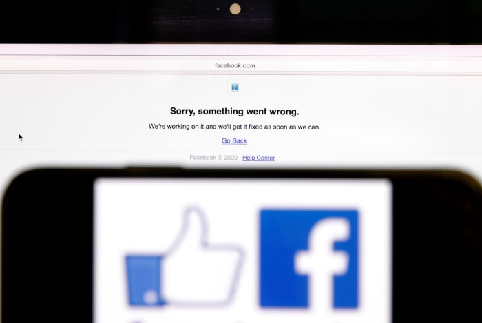 Nightly 10-25-21 photo 3 In this photo illustration, the Facebook logo is displayed next to a screen showing that Facebook service is down in San Anselmo, Calif.