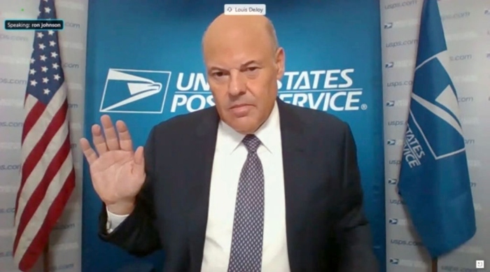 In this screenshot from the U.S. Senate's livestream, Postal Service Postmaster General Louis DeJoy is sworn in for a virtual Homeland Security and Governmental Affairs Committee hearing on U.S. Postal Service operations during Covid-19.