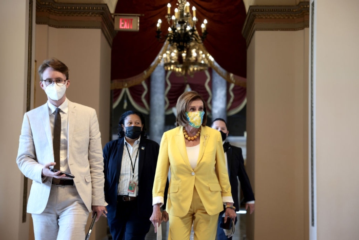 Nightly 8-24-21 photo House Speaker Nancy Pelosi speaks to a reporter as she walks to the floor of the House Chambers to give remarks at the U.S. Capitol.