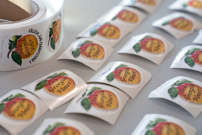 Stickers for voters sit on a table at a Cobb County voting location in Atlanta.