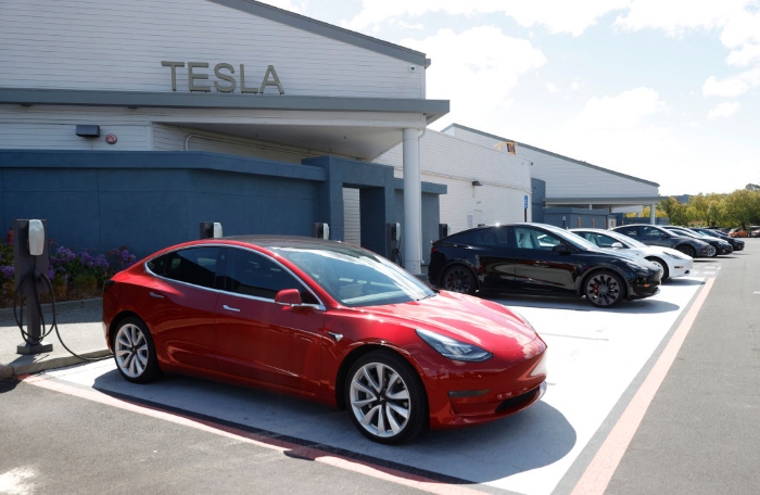 Nightly 10-8-21 photo 2 Tesla cars charge at a Tesla Supercharger station in Corte Madera, Calif.