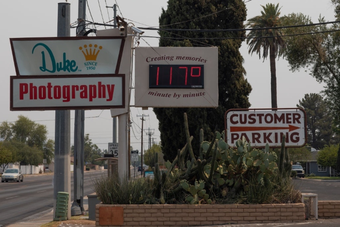 Nightly 7-2-21 photo A thermometer sign displays a temperature of 117 degrees Fahrenheit on June 15 in Phoenix.
