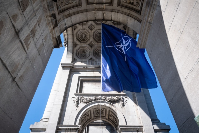 Nightly 10-18-21 photo 2 A NATO flag hangs from the Triumphal arch at Parc du Cinquantenaire in Brussels, Belgium.