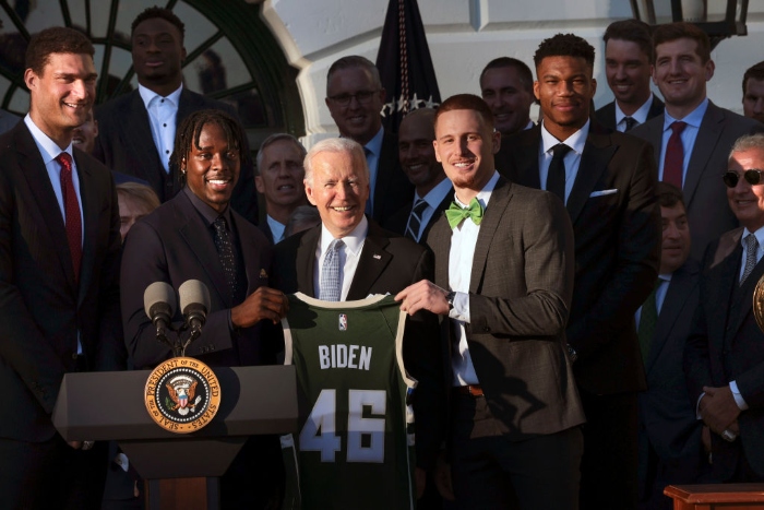 Nightly 11-8-21 photo 3 Biden (C) poses with members of the Milwaukee Bucks after receiving a jersey from owner Marc Lasry during an event where Biden honored the Bucks for winning the 2021 NBA Championship, on the South Lawn at the White House. The Bucks defeated the Phoenix Suns to win the 2021 championship.