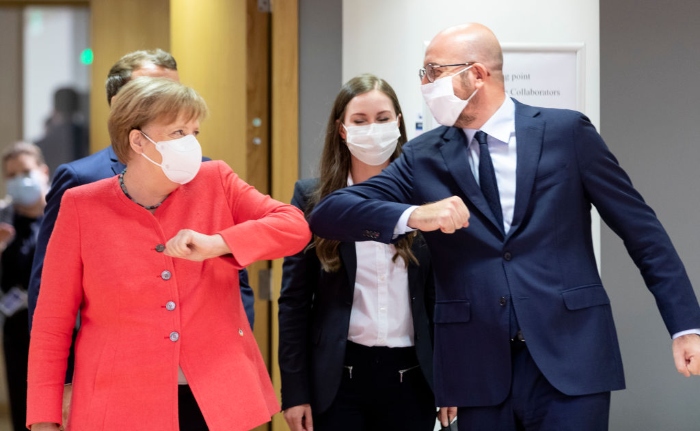 German Chancellor Angela Merkel elbow bumps the President of the European Council Charles Michel during an EU summit in Brussels, Belgium. Michel has called an extraordinary summit to discuss the EU's post-coronavirus recovery plan and the 2021-2027 budget.