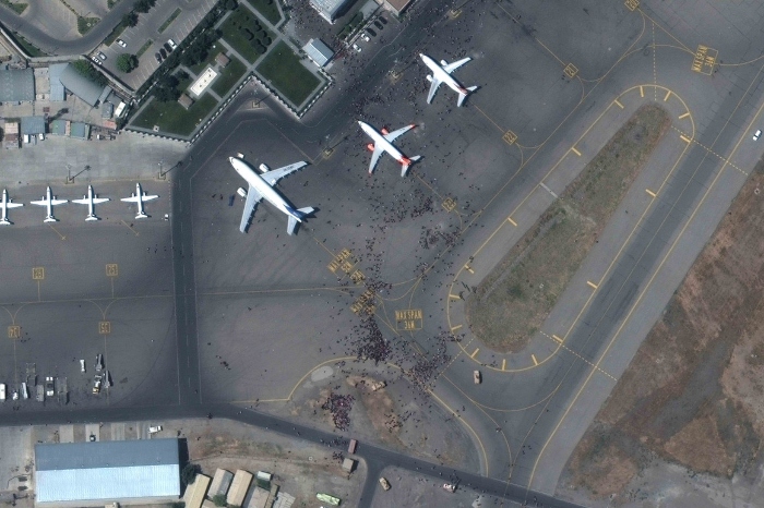 Nightly 8-16-21 photo This satellite photo from Maxar Technologies shows swarms of people on the tarmac at Kabul International Airport, also known as Hamid Karzai International Airport on Aug. 16.
