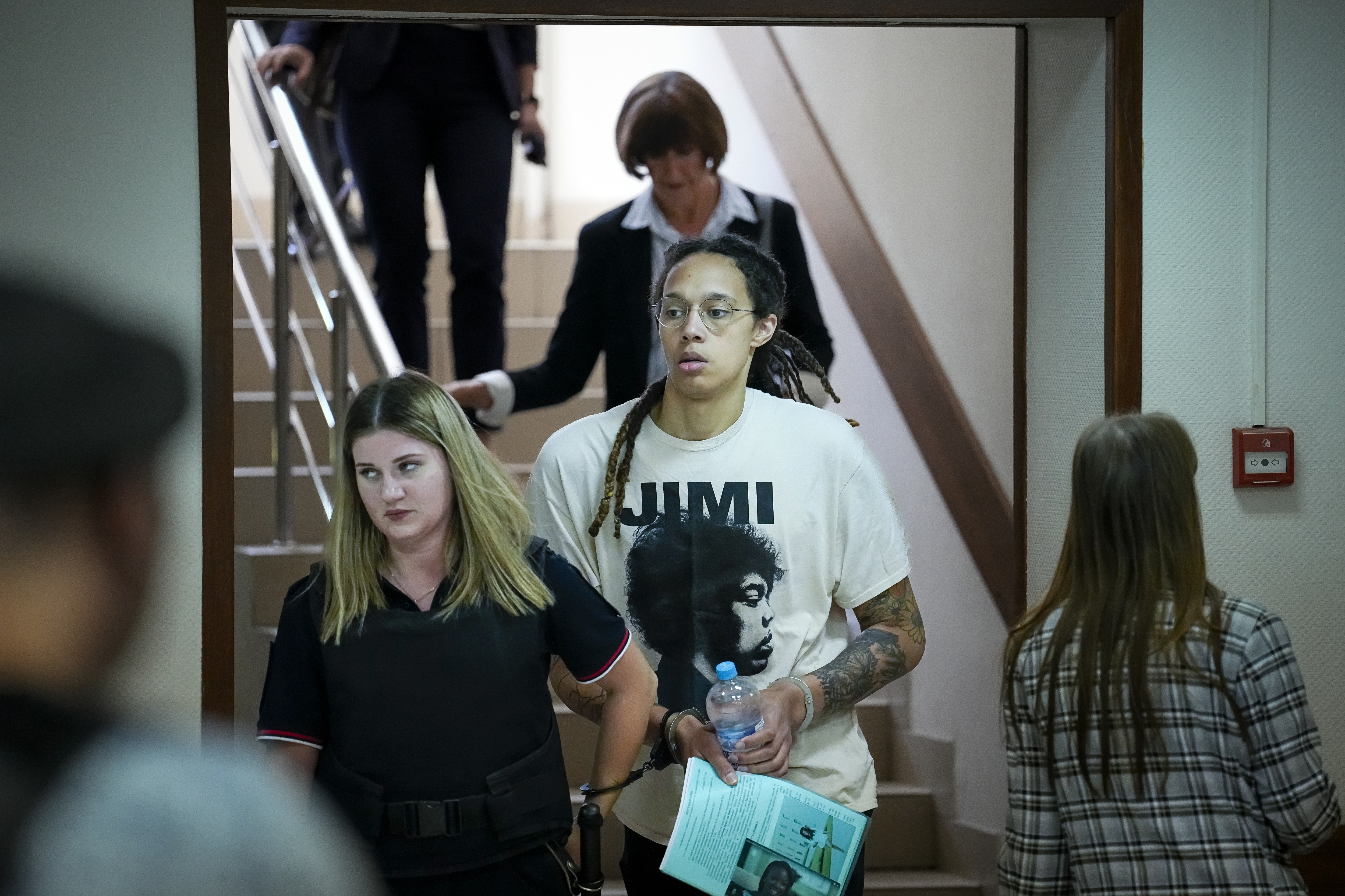 WNBA star and two-time Olympic gold medalist Brittney Griner is escorted to a courtroom.