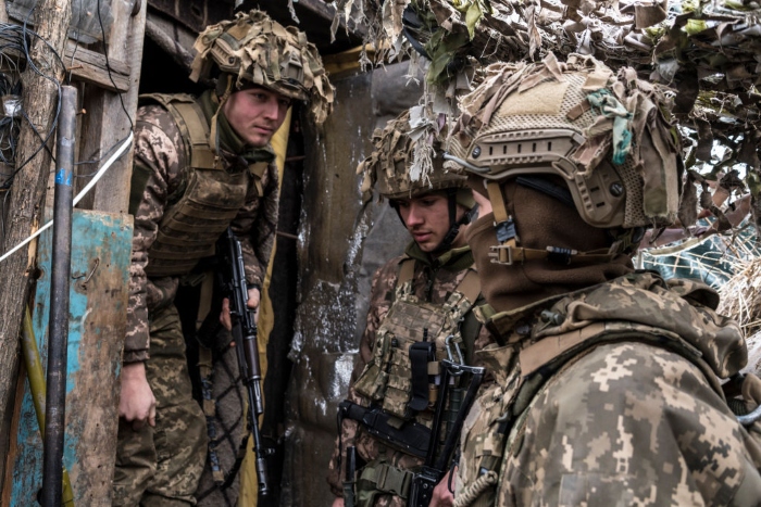 Nightly 1-21-22 photo 2 Ukrainian soldiers stand in a trench near the front line in the village of New York, formerly known as Novhorodske, Ukraine.
