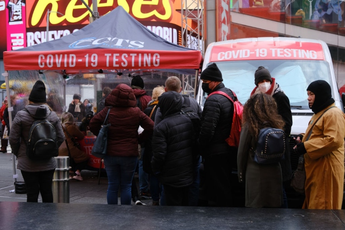 Nightly 12-9-21 photo People wait in line to get tested for Covid-19 at a testing facility in Times Square in New York City.